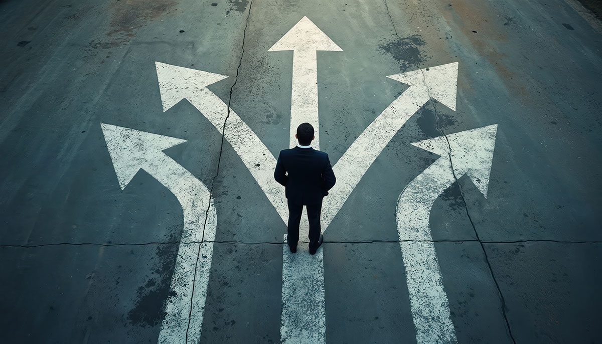 man standing on road picking a path