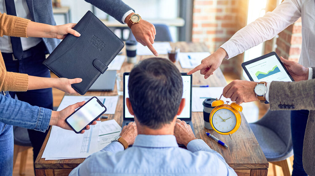 man surrounded by work tasks